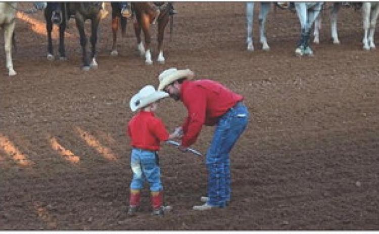 GENERATIONS OF TRADITION Post Stampede Rodeo volunteers prepared for the action in the arena during the 86th annual event. | AMY MASON PENNELL