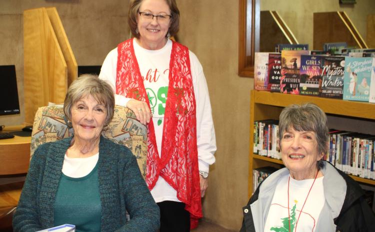 OPEN HOUSE Post Public Library hosted a Christmas Open House last Thurs. Dec. 14. Librarian Pam Humble served hot cider and cookies to avid readers Beth Cook and Carolyn Black. The library will be closed today through Dec. 26. Pam reminds everyone to come in next week, Dec. 27 through Dec. 29 and check out the new books selections. | JULIA CHILDS PHOTO