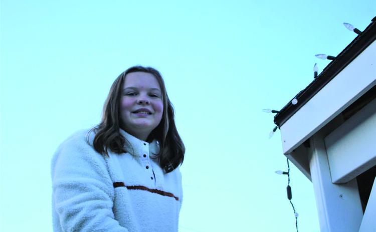 Adyson Parker a sixth grader at Post Middle School volunteered to hang lights at the park. Staff Photo