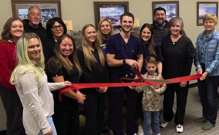 POST EYECARE Tuesday, November 19, Dr. Garrett Wentz cut the ribbon to the newly opened Post Eyecare located at the Garza County Healthcare District. In support are Traci Jarrett, Jacey Cathey, Randy Conner, Christina Jones, Dr. Xochitl Anderson, Brandy Fannon, Janie Suber, Dr. Garrett Wentz with his wife Kara and son Graham, Chita Hattaway, Jamie Hernandez, and JoAnn Travis. | ANNA GIBSON PHOTO