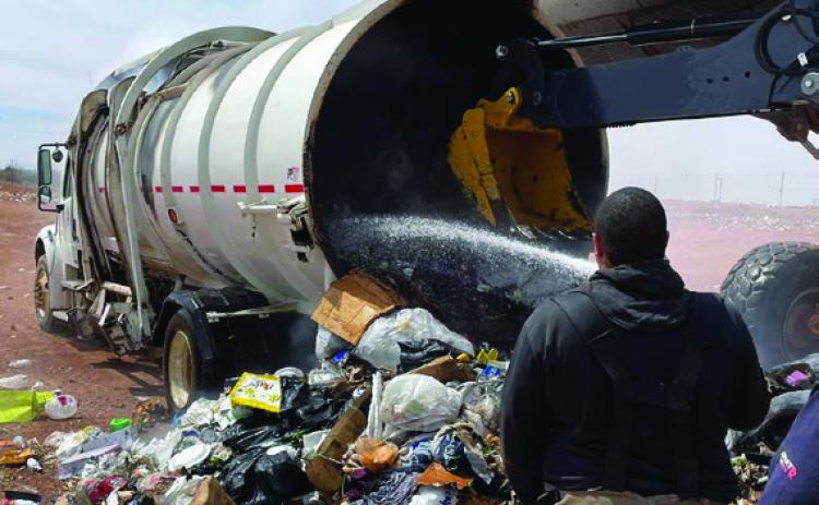 Post Volunteer Fire Department is shown spraying water on a trash fire contained in the city’s garbage truck. The truck is a total loss. Photo Provided