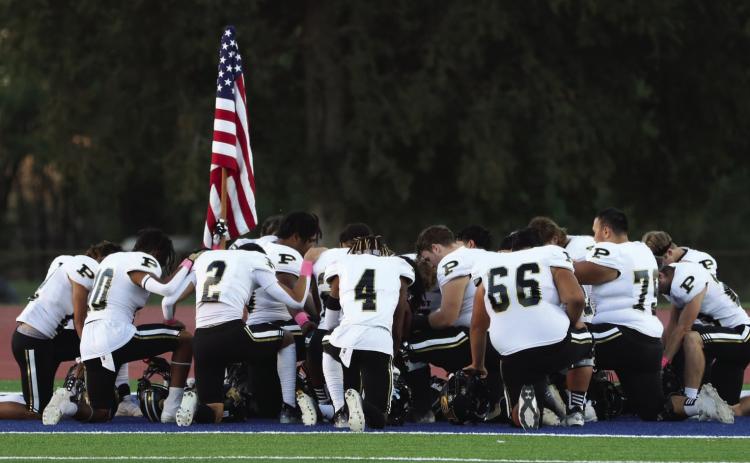 The Bold Gold Antelopes take a moment of silence before facing the Sundown Roughnecks in Week 9 action last Friday.