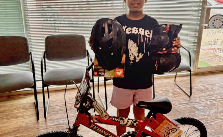 PARADE PRIZE Jonah Hernandez received his new bicycle after being selected as the winner of the boys’ drawing sponsored by Post Community Recovery Center during the Fourth of July Bicycle Parade. | COURTESY PHOTO