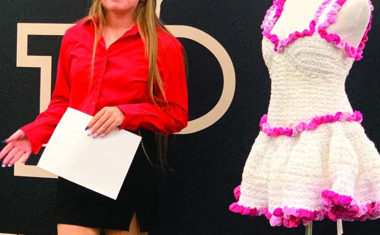 SHABBYTO CHIC Addisyn Gray gave a special presentation during the school board meeting, Monday, April 7, about her crocheted project that she entered at the Regional Repurpose and Redesign FCCLA. Gray said the project took 25 hours, three king-sized sheets cut into one-inch strips, and a few t-shirts. Gray was inspired by her grandmother who taught her how to crochet. | ANNA GIBSON PHOTO