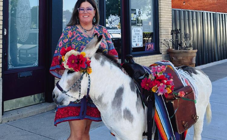 BIRTHDAY DONKEY Whitney Dorsett was surprised with a party for her 40th birthday by her husband and the help of her friends. Together they bought Senior Carrots. Courtney Howard decorated and made the flower crown for the donkey and Lacy Beck brought the donkey to town. Michele Liston was accommodating to allow Senior Carrots into the Winehouse! | COURTNEY HOWARD PHOTO
