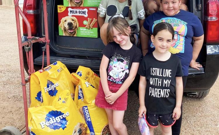 PAWS AND PURPOSE Members of the Post Girl Scouts visited the Post Animal Refuge Center (PARC) on Tuesday, April 14, spending time with shelter dogs and donating food and treats. The group learned about their community while supporting local animal care efforts. | POST DISPATCH