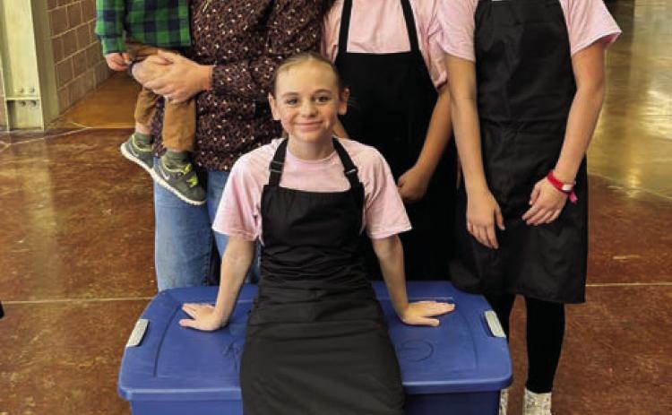 SPICE GIRLS The intermediate culinary artists pose for a picture as they wait in line before their cooking challenge at the Mallet Event Center in Levelland on Tuesday, November 5. The girls named themselves the Spice Girls. Behind them is their coach Hannah Gomez and little Jon Gomez, and the team, Elliot Talerico, Cenci Torres, and Daveigh Gomez. | XANE REITER PHOTO