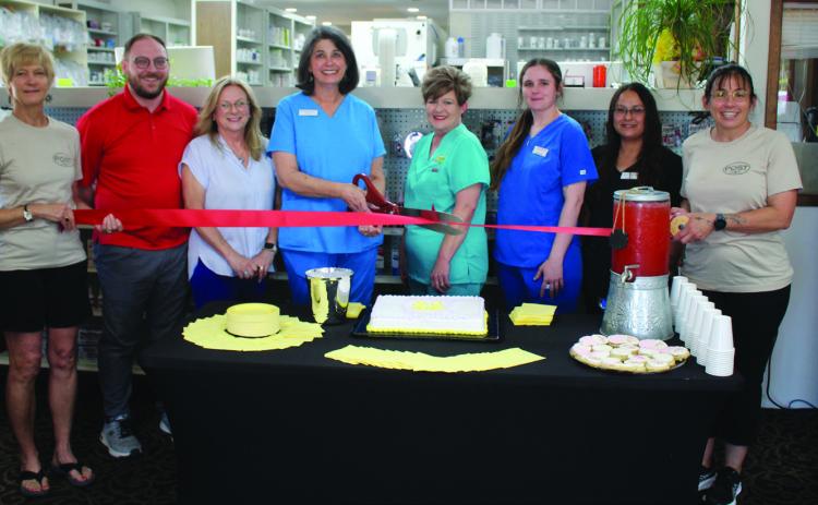 RIBBON CUTTING, Alisa Peters, owner of Hometown Pharmacy, is shown cutting a ribbon with the Post Chamber of Commerce for their business milestone of 20 years. Pictured are Chamber Board memberJoannTravis,PharmacistDanielCapps,ChamberBoardmemberSusanMcDonald,Ownerand PharmacistAlisaPeters,SherrieWilson,MeaganReiter,AndreaMenchaca,andChamberBoardmember Michele Liston. Peters says,“Thank you for letting me serve you for 20 years.” | ANNA GIBSON PHOTO