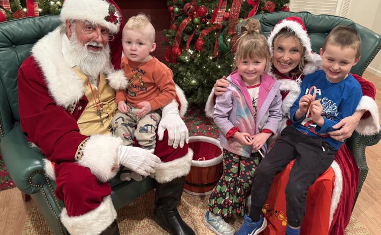 SANTA LISTENS to the Tara and Trent Lawrence family at last week’s Light Up Post evening.