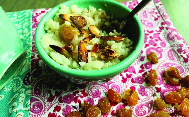 While rice is still hot and in the saucepan, stir in coconut milk, remaining teaspoon of vanilla, and maple syrup. Add the raisins and let cook, stirring occasionally, for 15 minutes. Preheat broiler. Place almonds onto a small baking pan. Sprinkle evenly with sugar. Place under the broiler for 2 to 3 minutes to toast until golden brown, (watch closely to avoid burning). Divide pudding into dishes to serve, and top with a portion of brûléed almonds. Makes 3 to 4 servings. Photo by Angeline LaRue