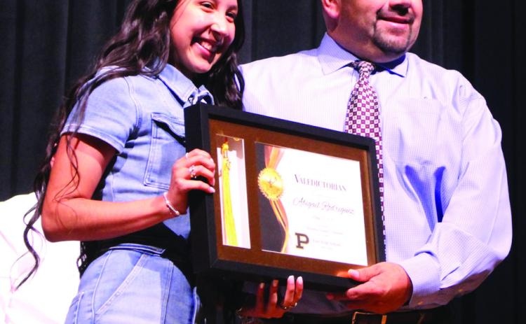 VALEDICTORIAN PHS Principal Sol DeLeon presents Abigail Rodriguez with the 2024Valedictorian Award during the Academic Awards Ceremony on Monday. Abigail is the daughter of Steve andMineraRodriguezandgranddaughterofGusandIrmaGomez. She has earned 50 dual credits. After high school, Abigail plans to attend LCU and work toward a Bachelor of Science degree in Nursing. | JULIA CHILDS PHOTO
