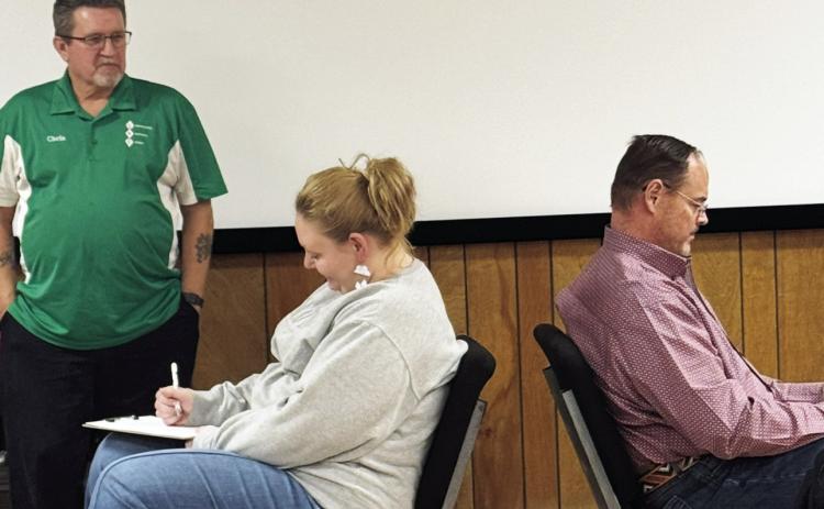 POST ROTARY CLUB Chris Atkinson (left), Director of the Community Recovery Center (CRC), guided Anna Gibson and Rhett Parker through a demonstration that highlighted the challenges and significance of communicating effectively with individuals struggling with addiction during his presentation to the Post Rotary Club members at their regular meeting on Tuesday, Feb. 10, in the CRC building. | COURTESY PHOTO