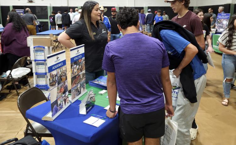 WTC COLLEGE FAIR COMING UP Isrell Lawson, WTC’s Welcome Center and Enrollment Outreach Director, speaks with prospective students at the 2025 Western Texas College Fair. | COURTESY PHOTO