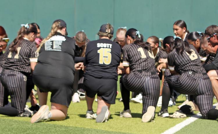 LADY LOPES Members of the Post High School Lady Lopes softball team gathered for a pregame prayer before their bi-district playoff game April 24 at Lubbock Christian University. | COURTESY PHOTO