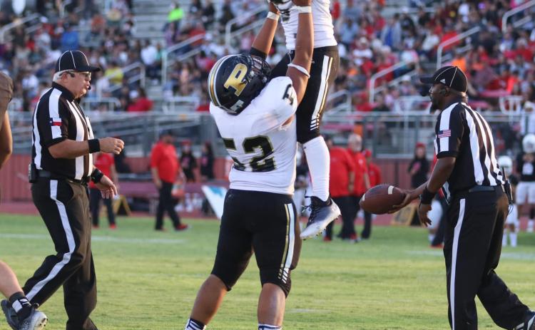 Celebrating by flying high, Bold Gold player Alejandro Rodriguez (Sr.) lifts up running back Ian Vergara (Jr.) as they celebrate a successful play. ABIGAIL RODRIGUEZ PHOTO