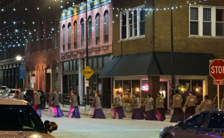 SURREAL SCENE in predawn downtown Springfield, Missouri, April 30 is really nothing more than the Southwest Missouri State flag corps proceeding to their lineup point for the filming of an NBC-TV“Today Show Third Hour Live”segment on the birthplace of Route 66.