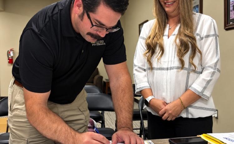 NEW BOARD MEMBER Brandy Fannon administered the oath of office to Dakota McDonald, who was appointed to fill the open Precinct 1 position on the Garza County Healthcare District Board during its Sept. 16 meeting. | COURTESY PHOTO