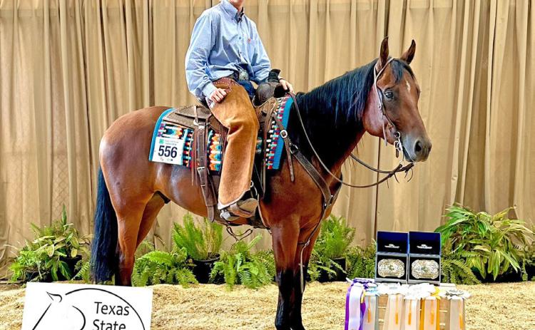 Right: Kasen Wink with his award ribbons and buckles for Reserve Champion Stock Horsemen and 1st place in Horse Trail